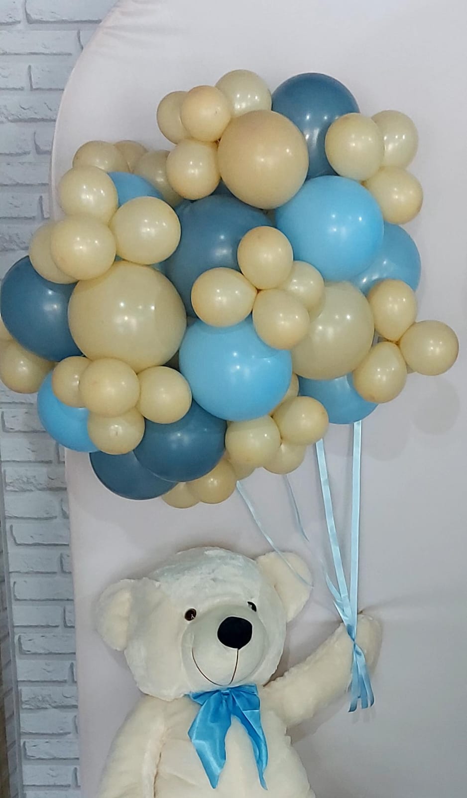 Balões para decoração, com um urso grande segurando vários balões